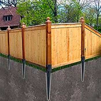 Fence with Posts Supports by Metal Ground Anchors Staked into Soil without Concrete